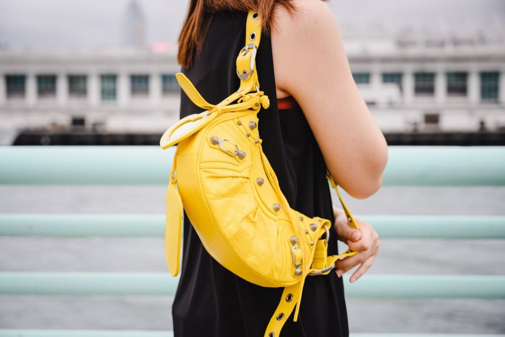 Person holding a bright balenciaga le cagole yellow bag