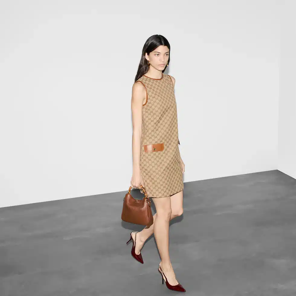 Woman in stylish dress and Gucci Diana small shoulder bag.