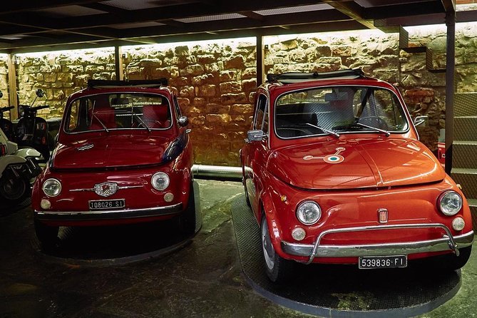 Vintage Fiat 500 driving through the Tuscan hills