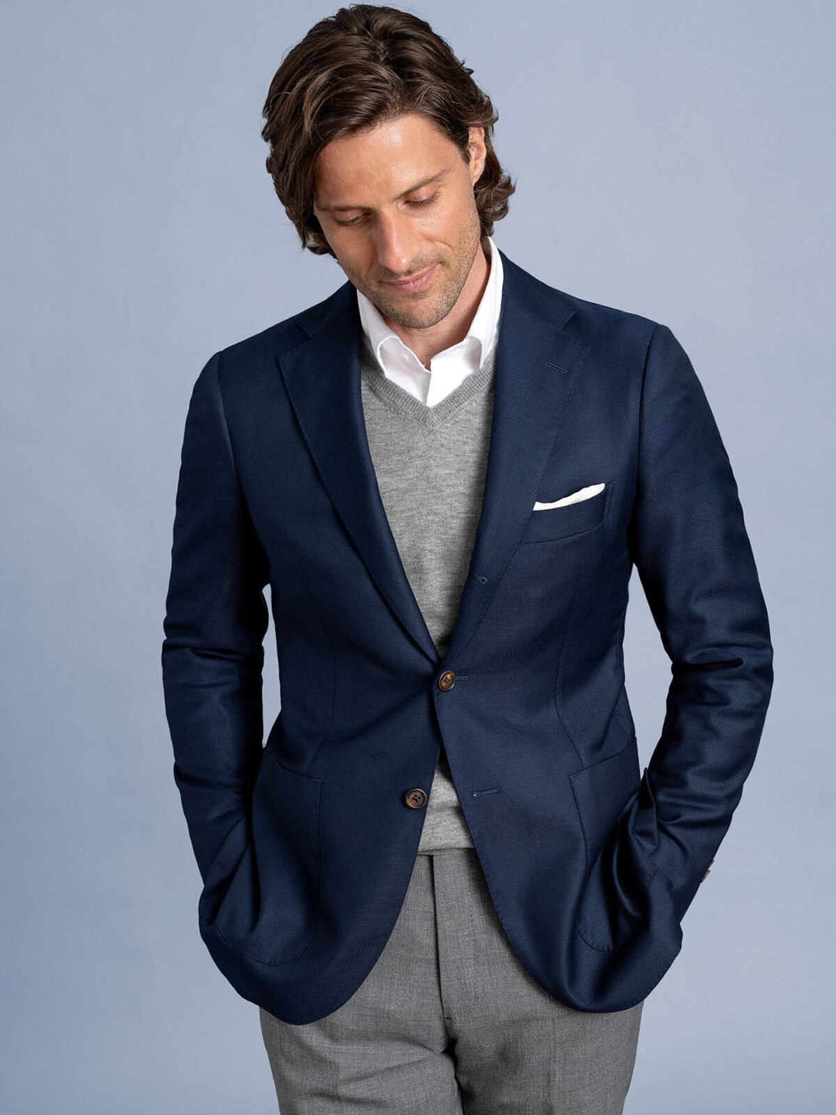 Fine-gauge merino wool sweater worn beneath a tailored blazer