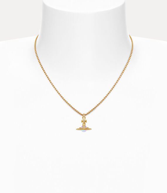 Model styling a Vivienne Westwood Orb pendant with a simple neckline