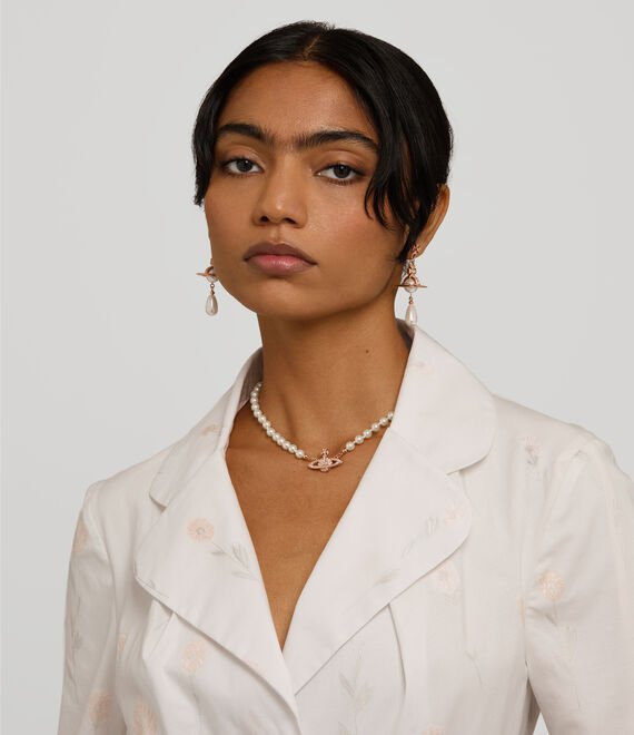 Vivienne Westwood pearl necklace shown at the base of the neck