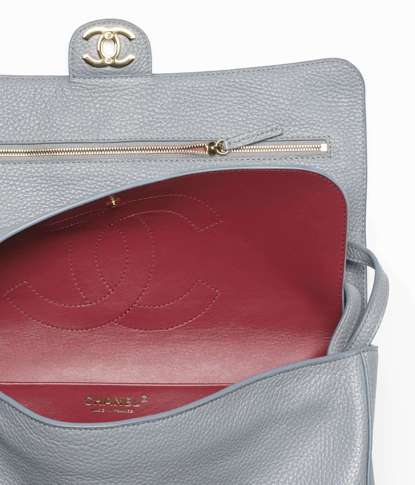 Side view of grey Chanel Maxi Flap Bag showing its depth