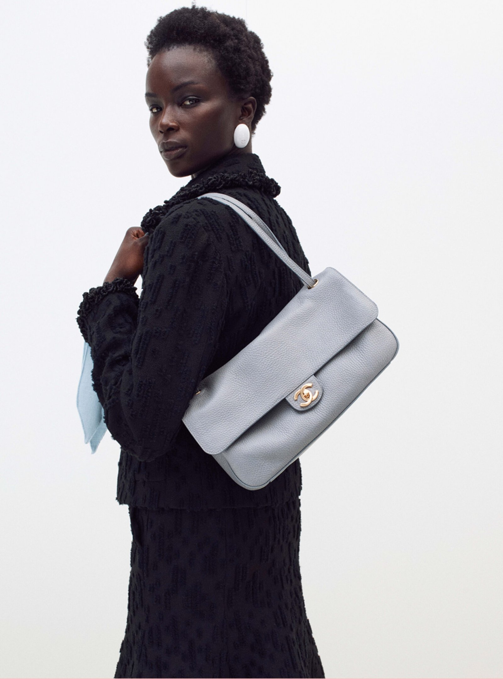 Grey Chanel Maxi Flap Bag shown on a model in Chanel look 32