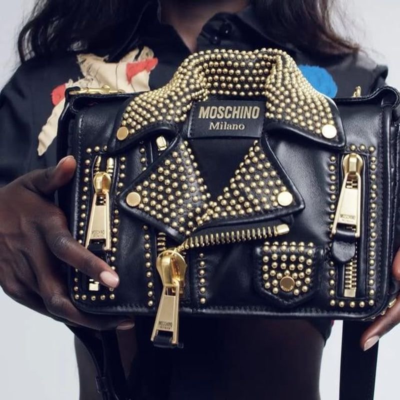 Black Moschino Biker Bag with gold studs shown in a Moschino campaign.
