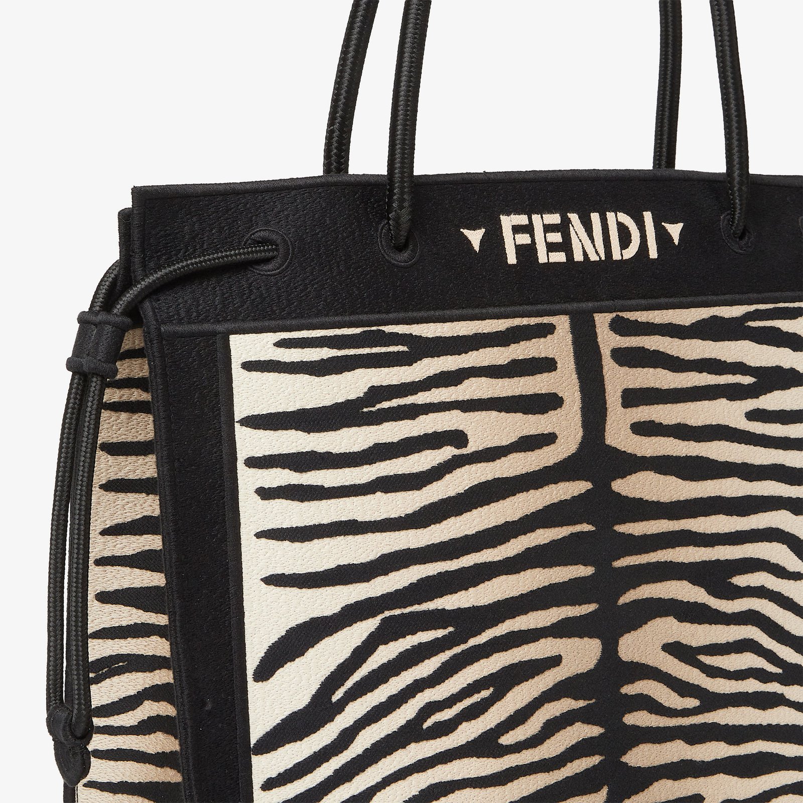 Close-up of tiger-effect embroidery and cord handle on the Fendi Magic Shopper.