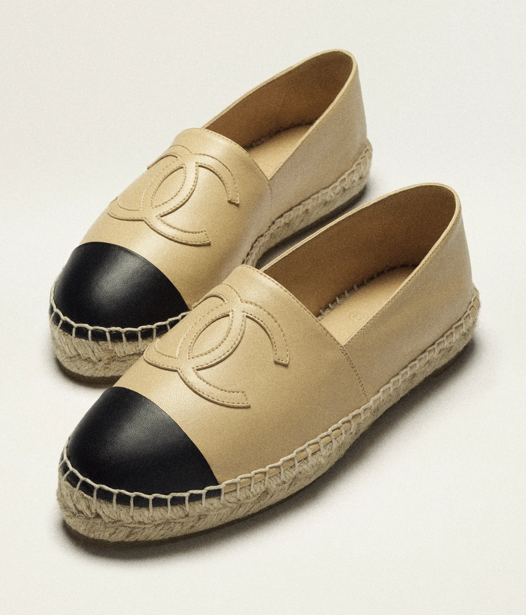Construction details on beige and black Chanel espadrilles.