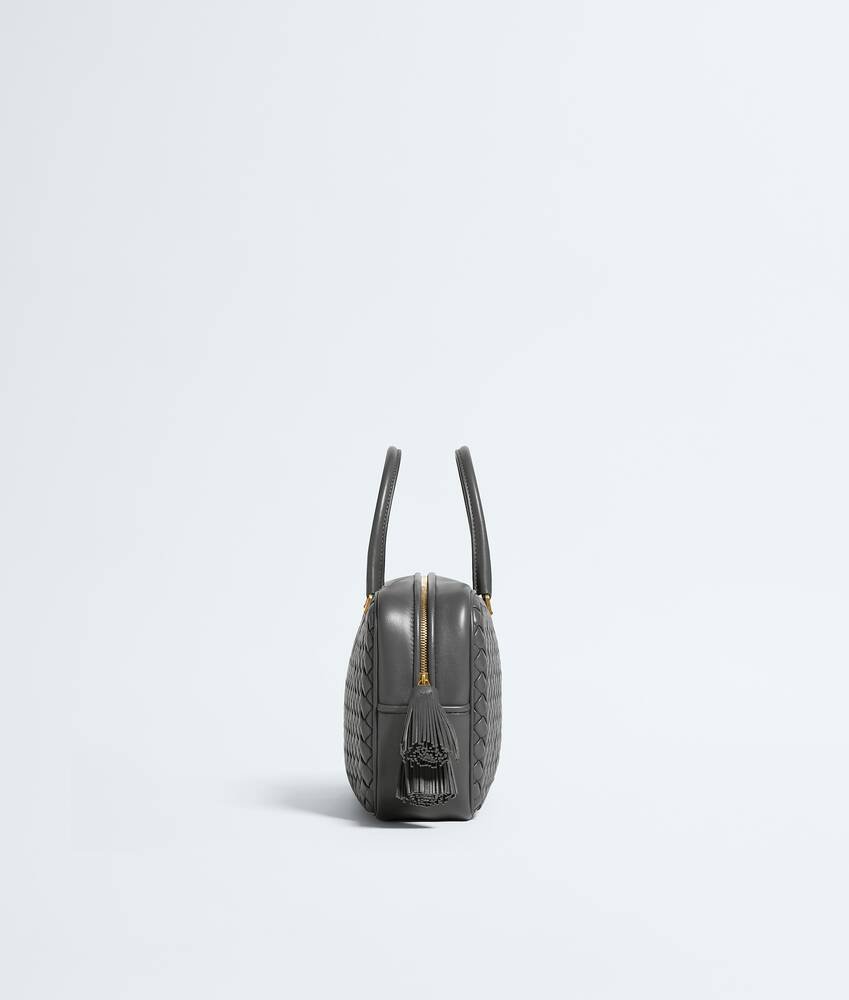 Close-up of Intreccio leather and zipper detail on the Small Elio