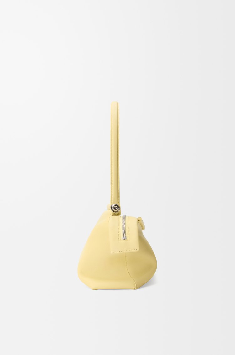 Vanilla Loewe Whisker Bag shown upright with its strap laid beside it