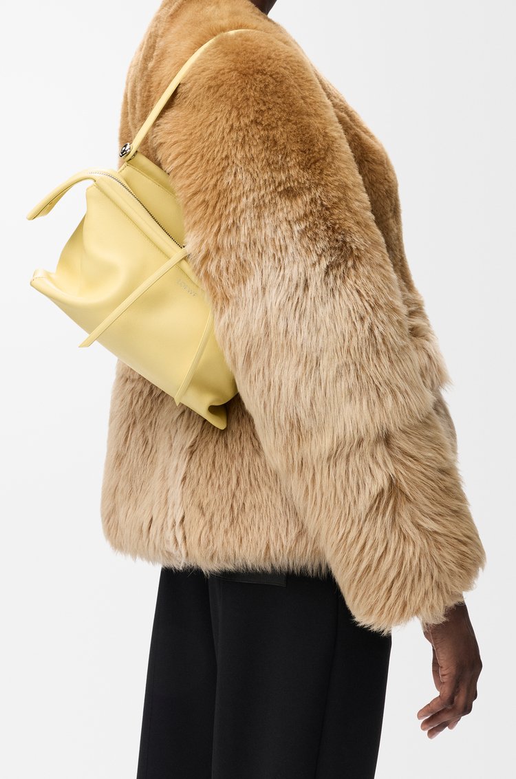 Vanilla Loewe Whisker Bag showing its curved handle and articulated zip pulls