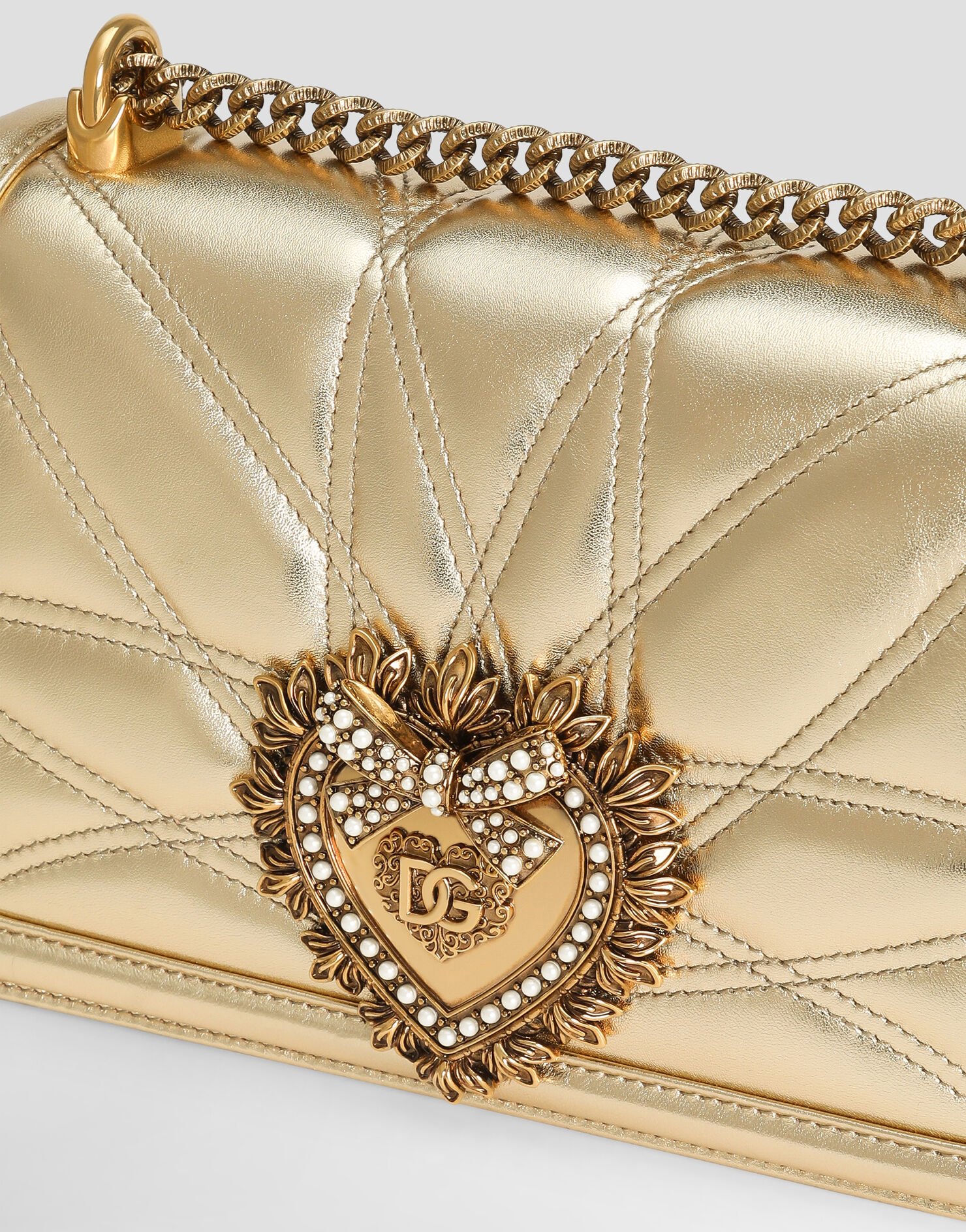 Close-up of the Dolce & Gabbana Devotion Bag heart clasp and quilted leather.