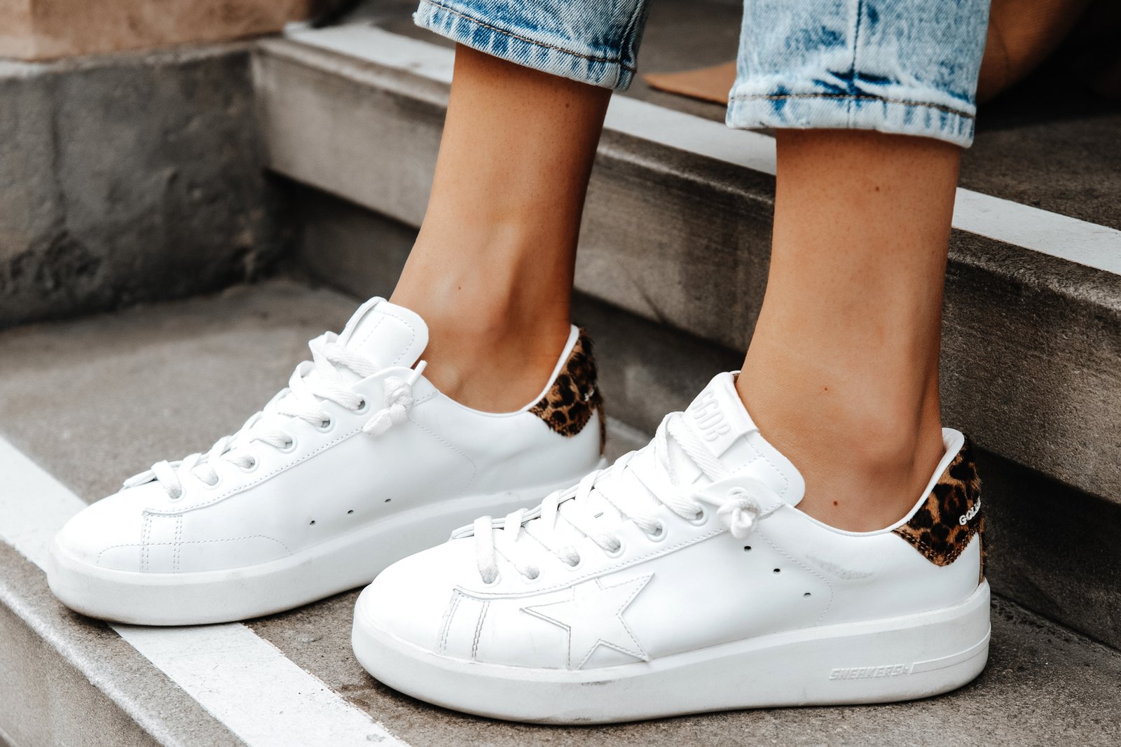Golden Goose Purestar sneakers shown closely on the feet