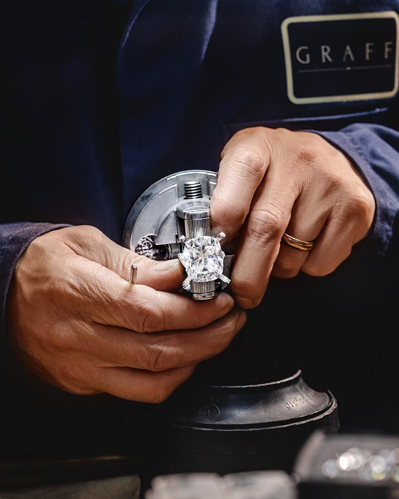 Graff artisan examining a diamond jewel during production.