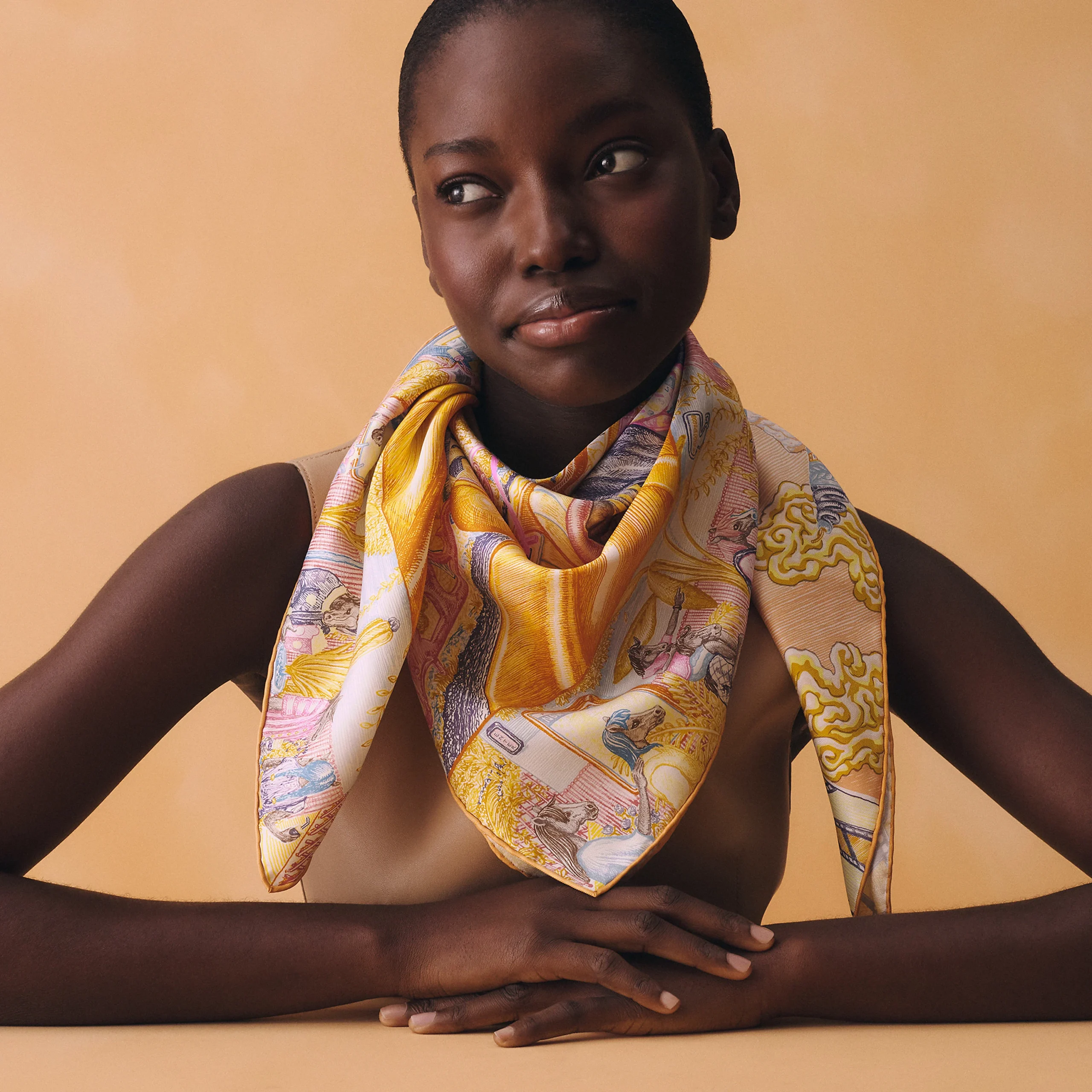 Model wearing the Hermès City of Light Carré 90 silk scarf.