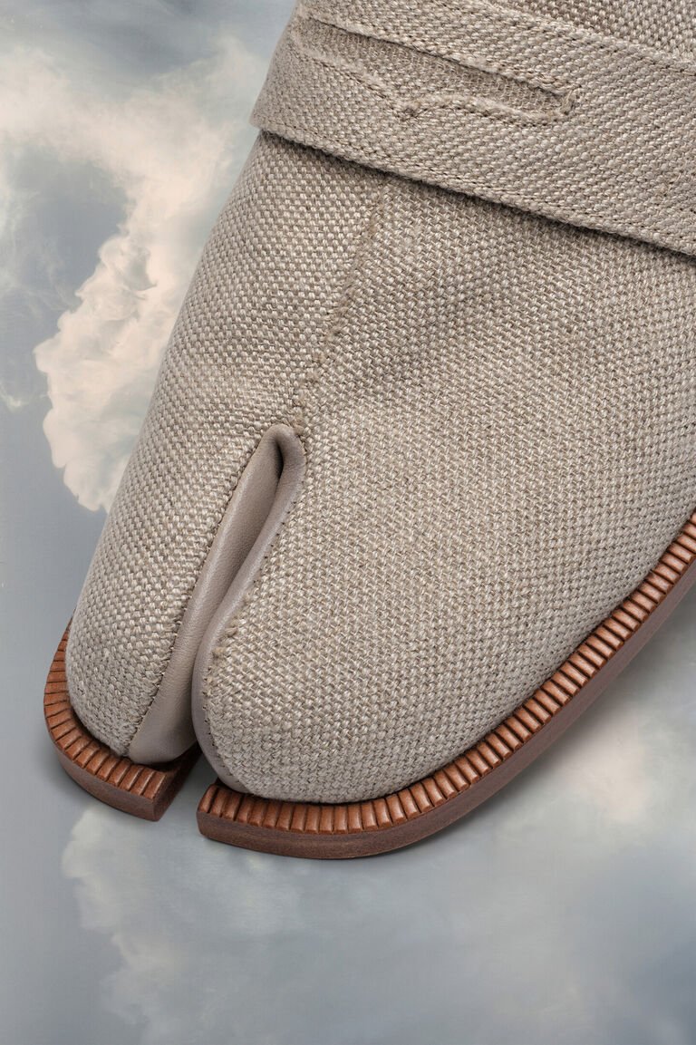 Beige canvas Maison Margiela Tabi shoe showing its split-toe construction