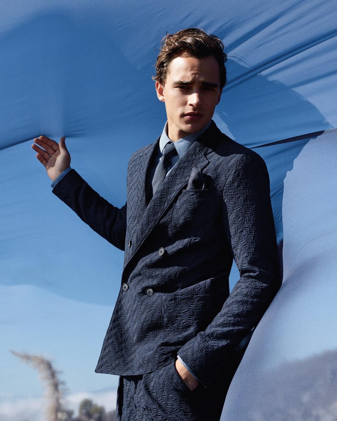 Close-up of a Giorgio Armani navy double-breasted suit with relaxed shoulders.