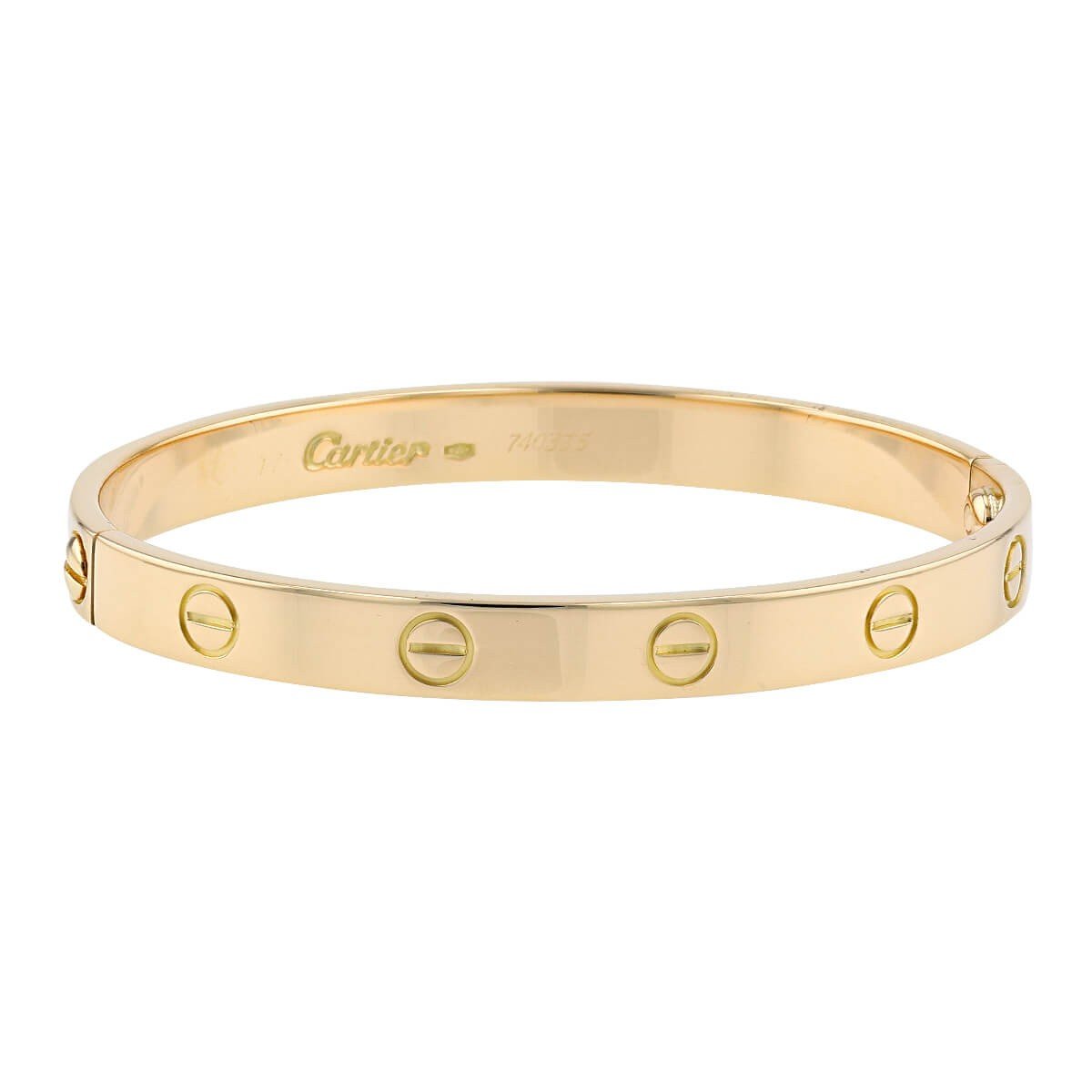 Yellow-gold Cartier Love Bracelet displayed with its screwdriver.