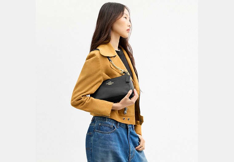 Detail view of the Coach Teri Shoulder Bag zip-top closure.