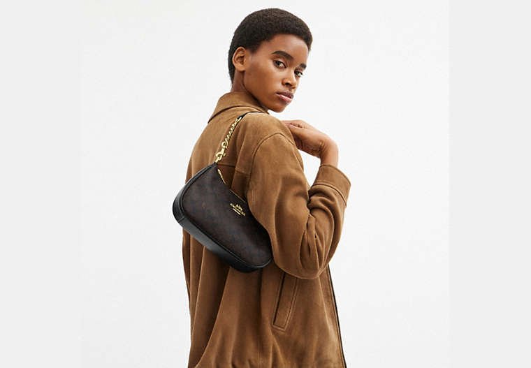 Coach Teri Signature Canvas bag styled for shoulder wear.
