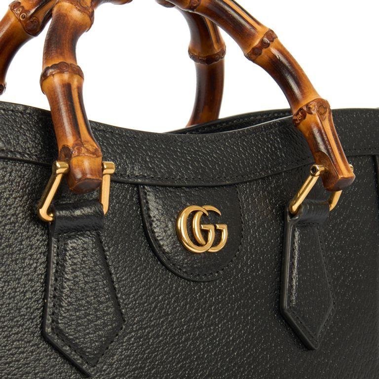 Bamboo handle, leather belt and Double G details on a Gucci Diana bag.