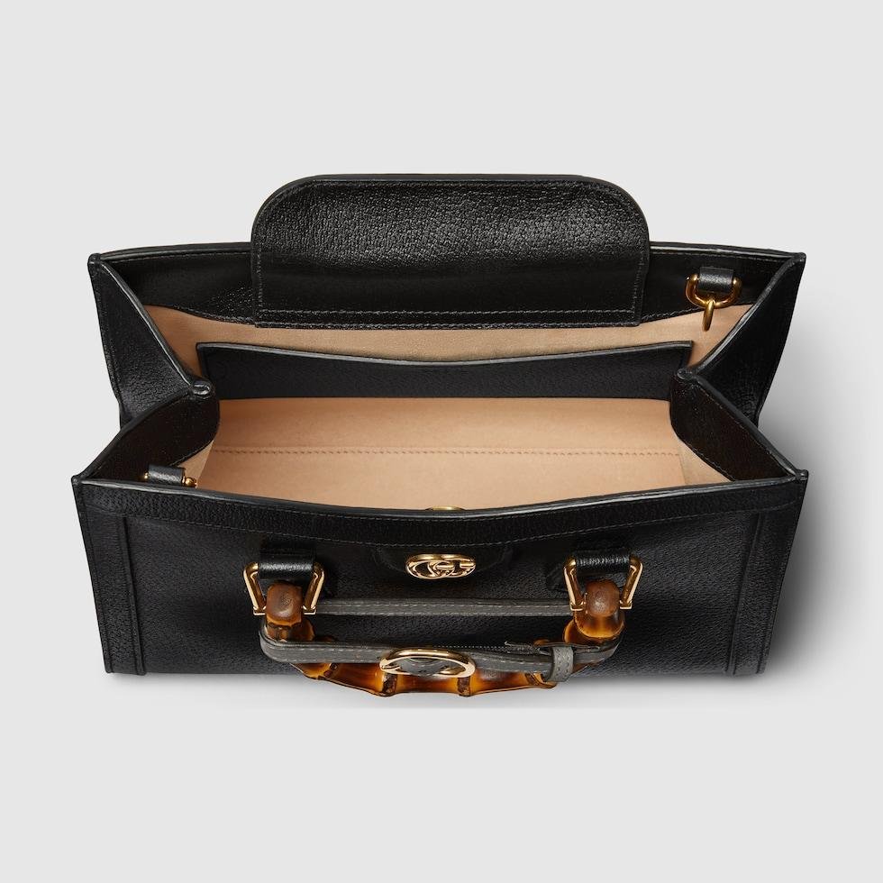 Open black Gucci Diana bag showing its interior capacity.