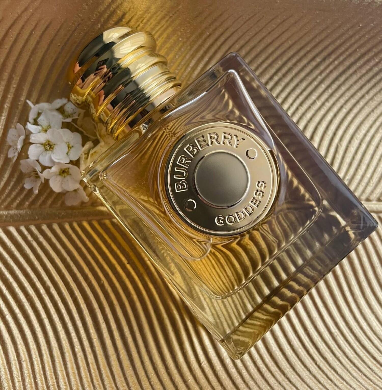Burberry Goddess bottle photographed in an abstract warm-gold setting.