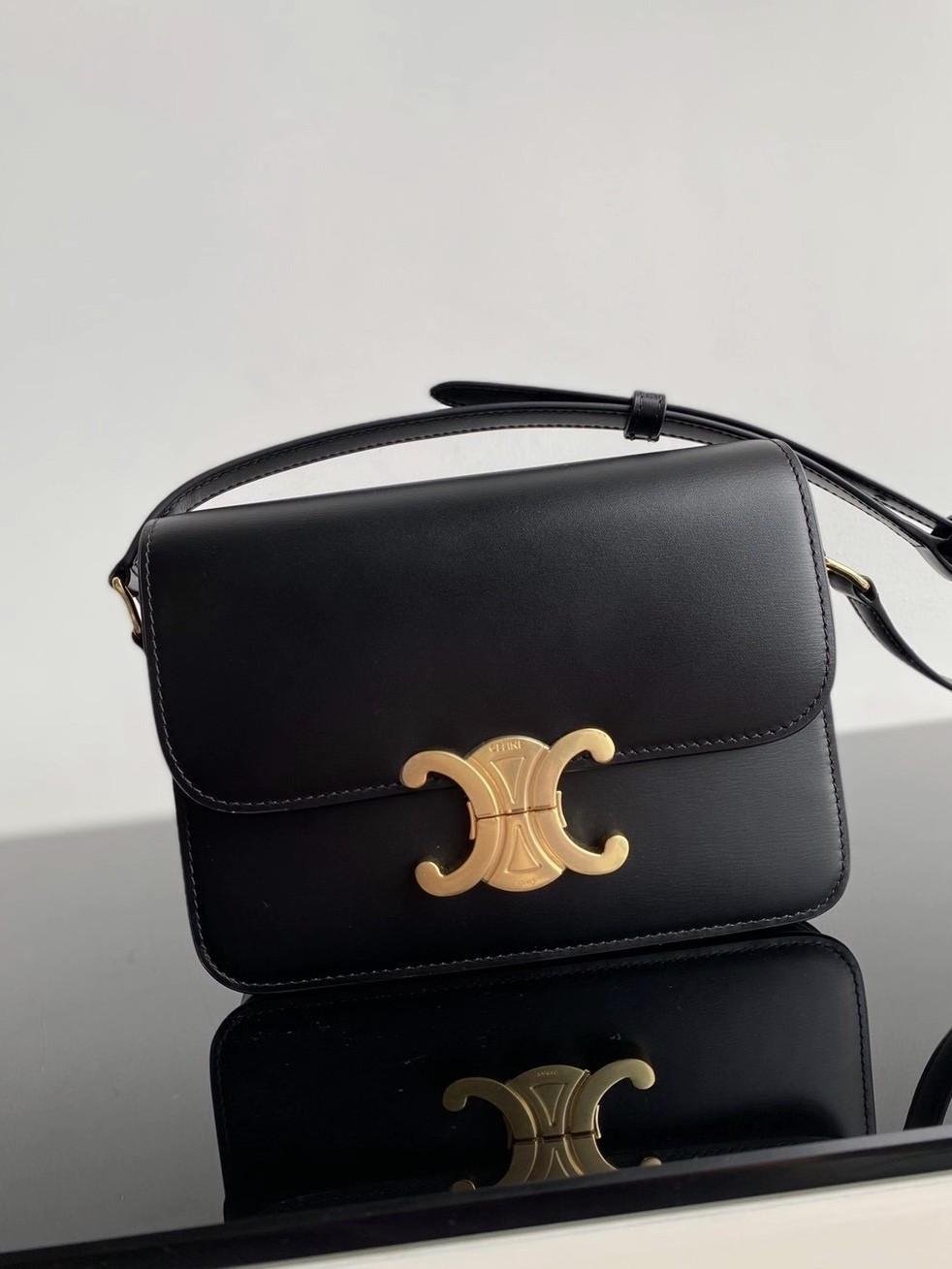Black Celine Triomphe bag displayed to show its structured proportions and hardware.