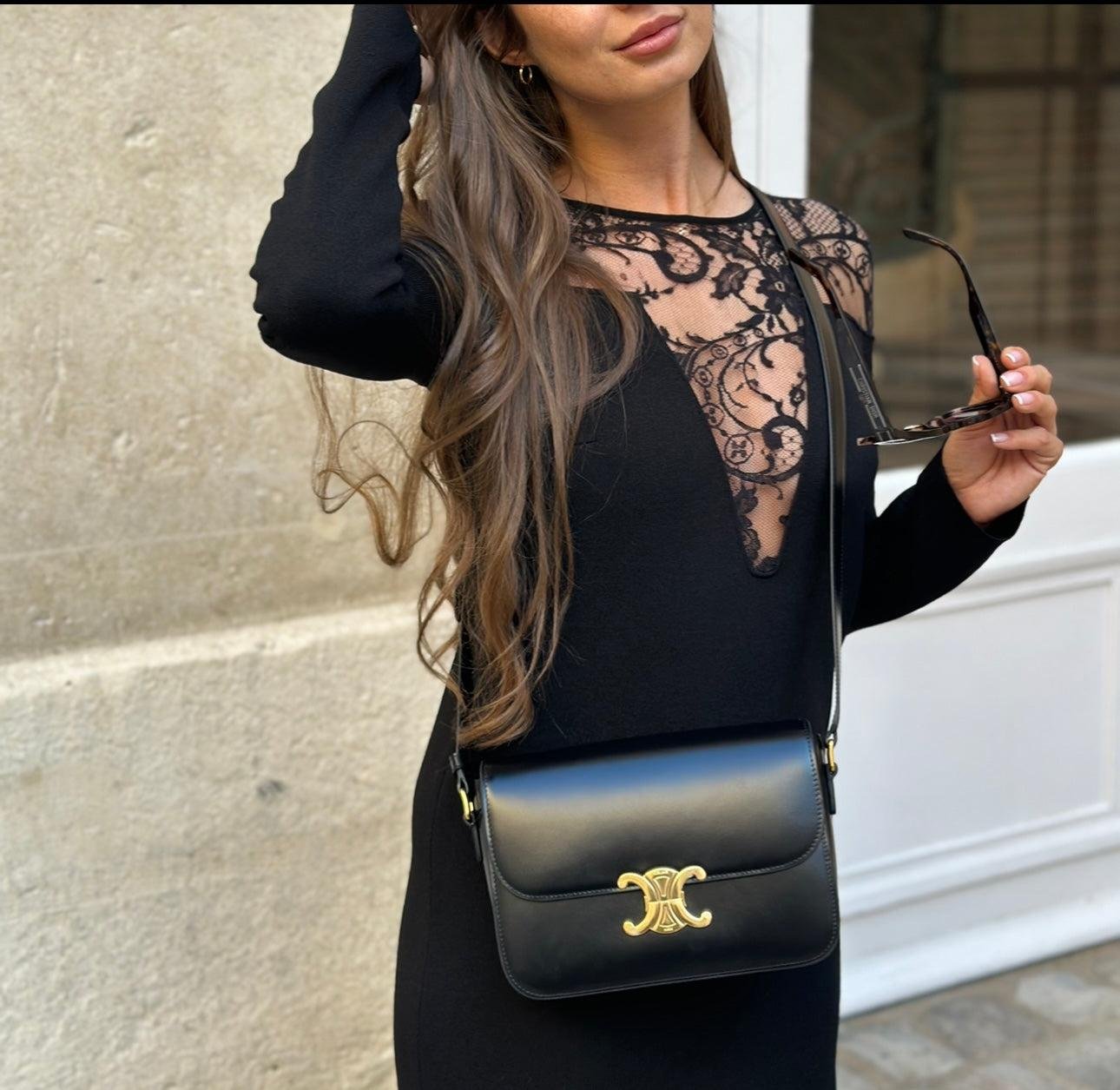 Model styling a black Celine Triomphe crossbody bag with an evening outfit.