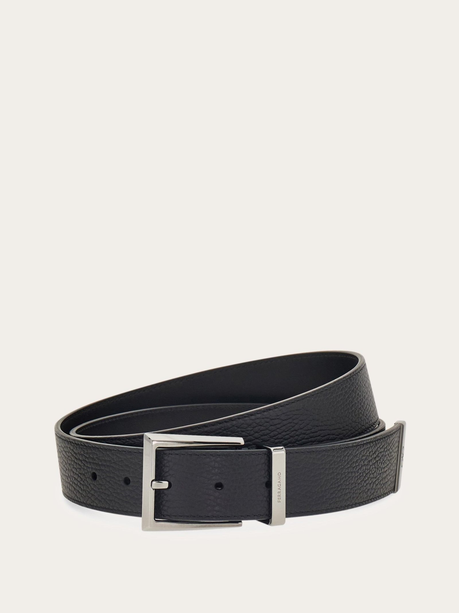 Ferragamo reversible belt displayed to show its contrasting leather sides.