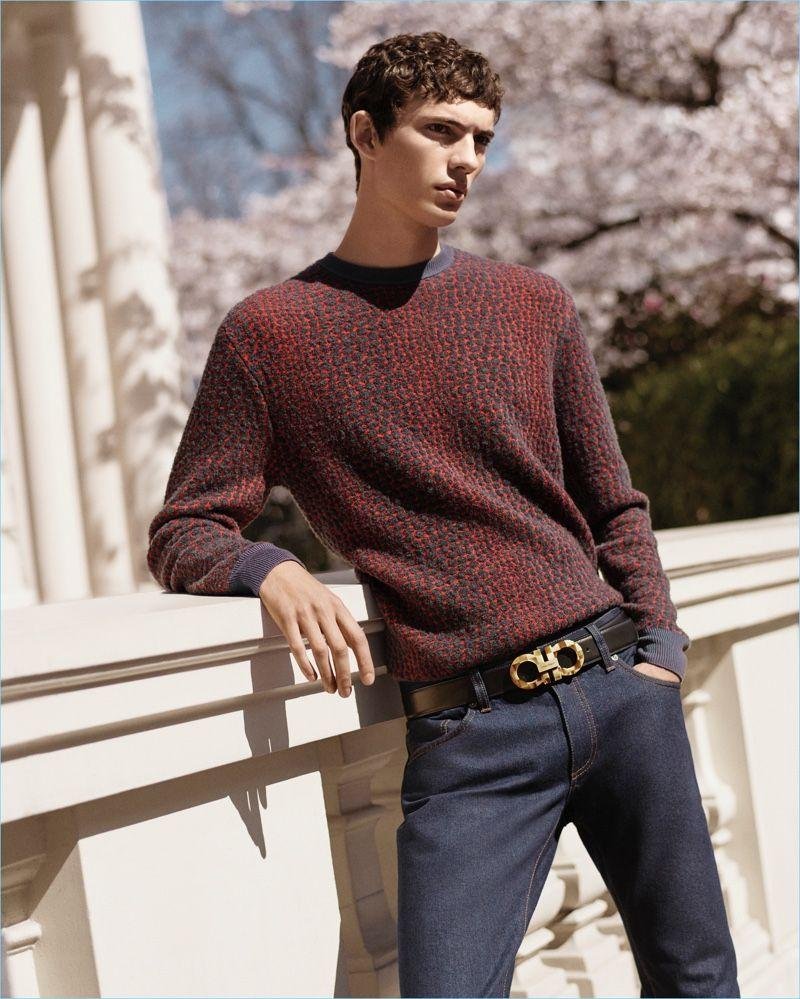 Man styling a Ferragamo belt with a burgundy knit and tailored trousers.