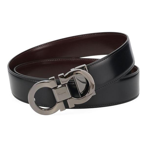 Black and brown reversible Ferragamo Gancini belt displayed in a circular arrangement.
