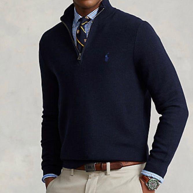 Model wearing a cream Ralph Lauren quarter-zip sweater with dark jeans.