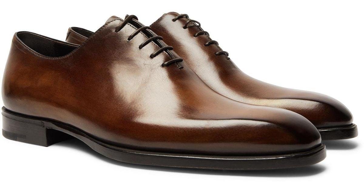 Berluti Venezia leather shoes displaying brown and blue hand-applied patinas.
