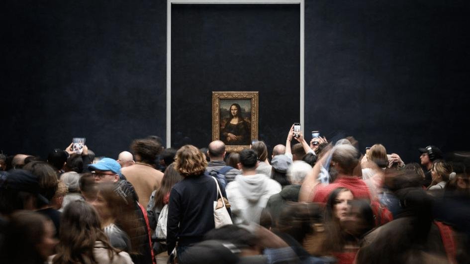 Visitors gathered in front of the Mona Lisa at the Louvre.