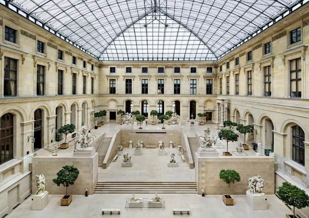 French sculptures displayed beneath the glass roof of the Cour Marly.
