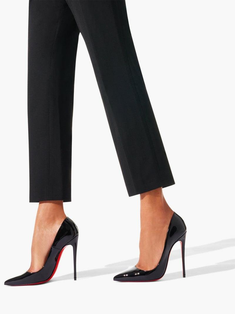 Black Christian Louboutin So Kate pumps worn with tailored trousers.