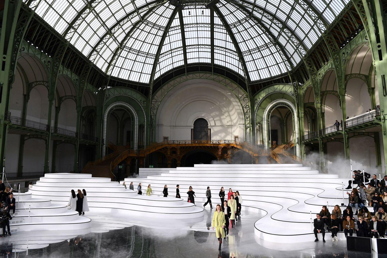 Chanel runway presentation inside an elaborate glass-roofed venue.