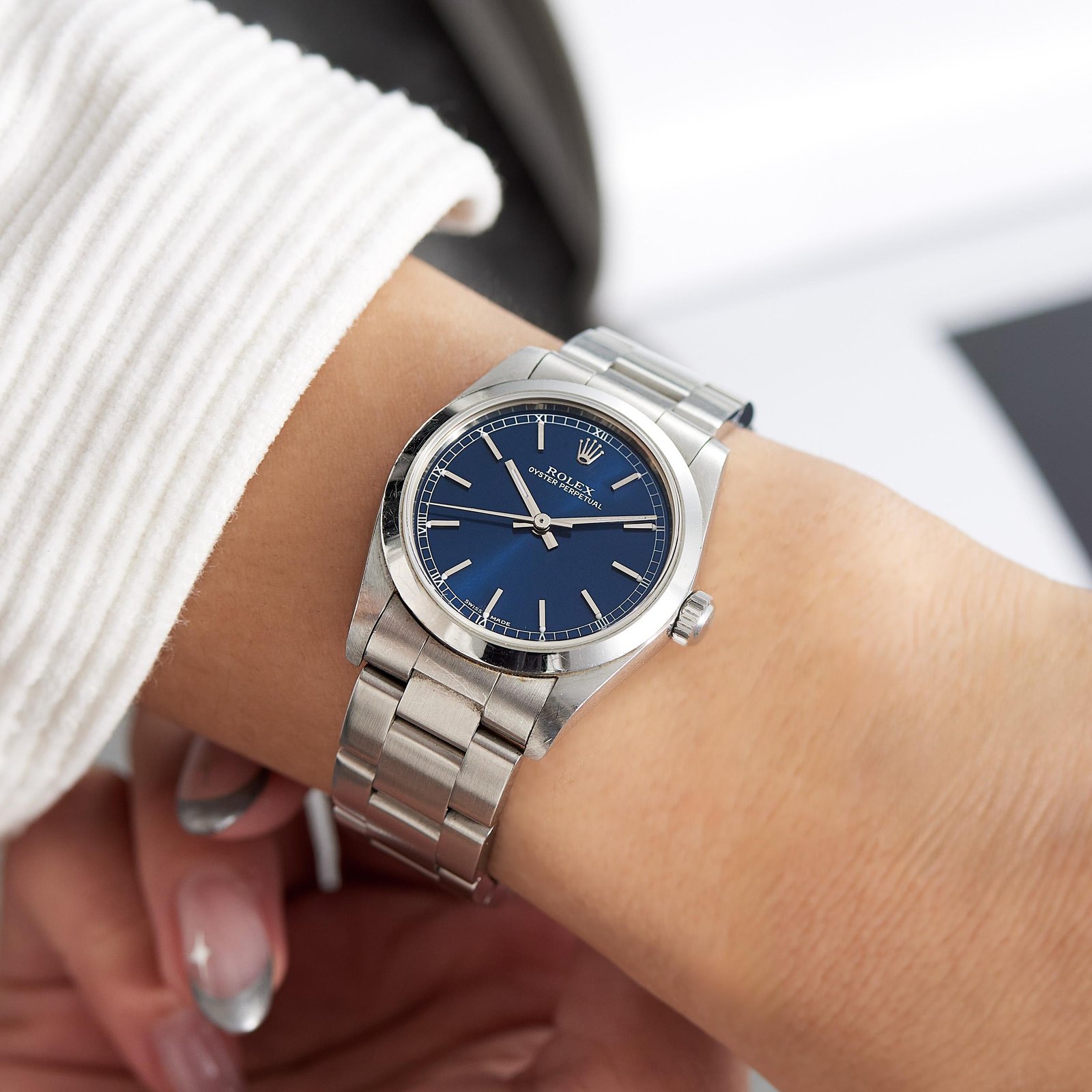 Blue-dial Rolex Oyster Perpetual worn comfortably on the wrist.