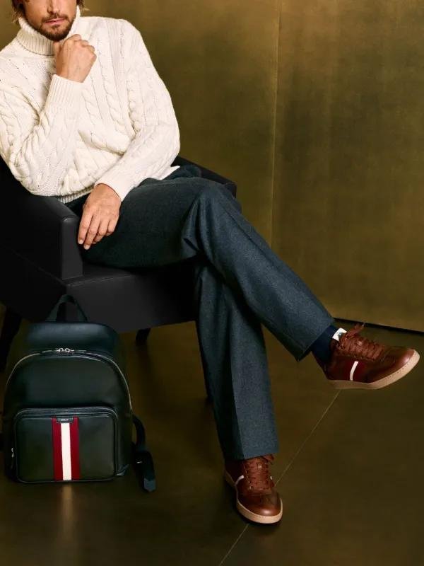 Model wearing polished brown Bally shoes with tailored trousers.
