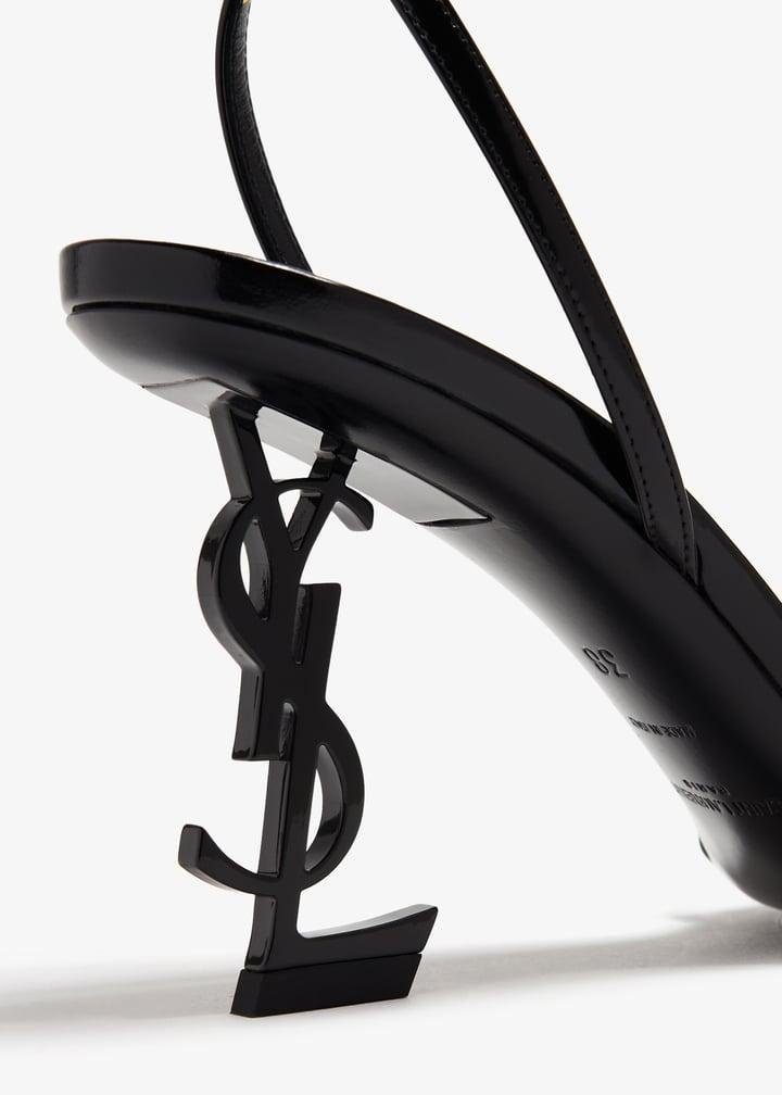 Close-up of the sculptural YSL logo heel on a Saint Laurent Opyum sandal.