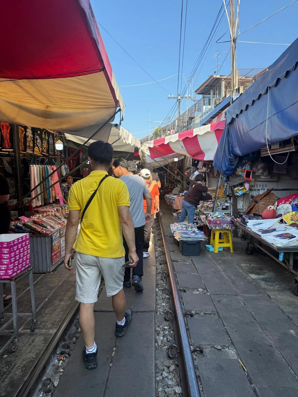 Narrow pedestrian space between stalls at Maeklong Railway Market.