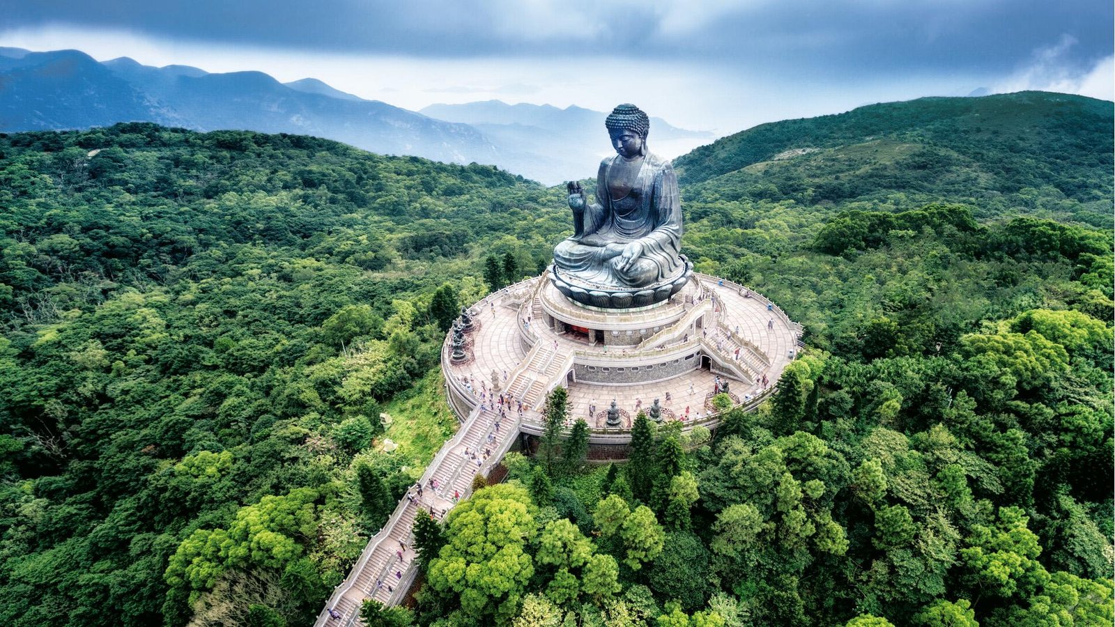 Tian Tan Buddha overlooking the mountains of Lantau Island in Hong Kong.