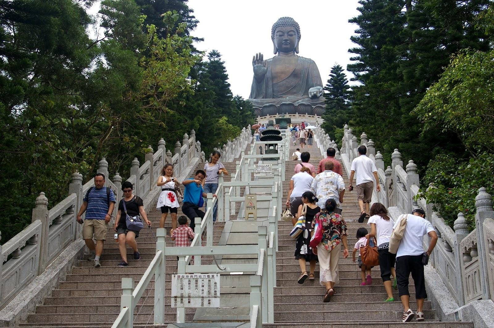Visitors climbing the staircase beneath Tian Tan Buddha.
