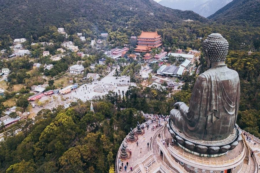 Tian Tan Buddha and Po Lin Monastery surrounded by Lantau Island mountains.