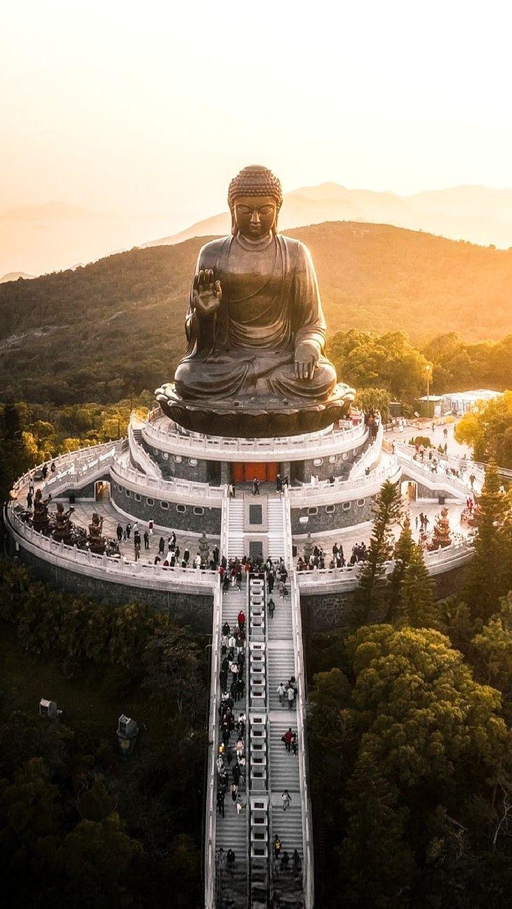 Tian Tan Buddha surrounded by mist and mountain scenery on Lantau Island.