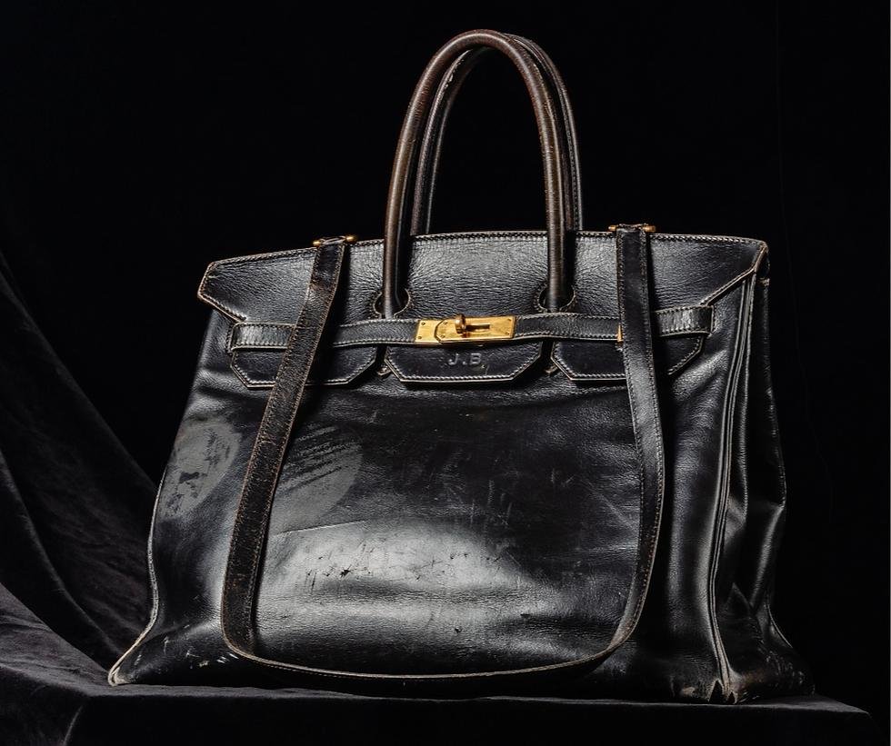 A visibly used black Hermès Birkin displayed for resale.