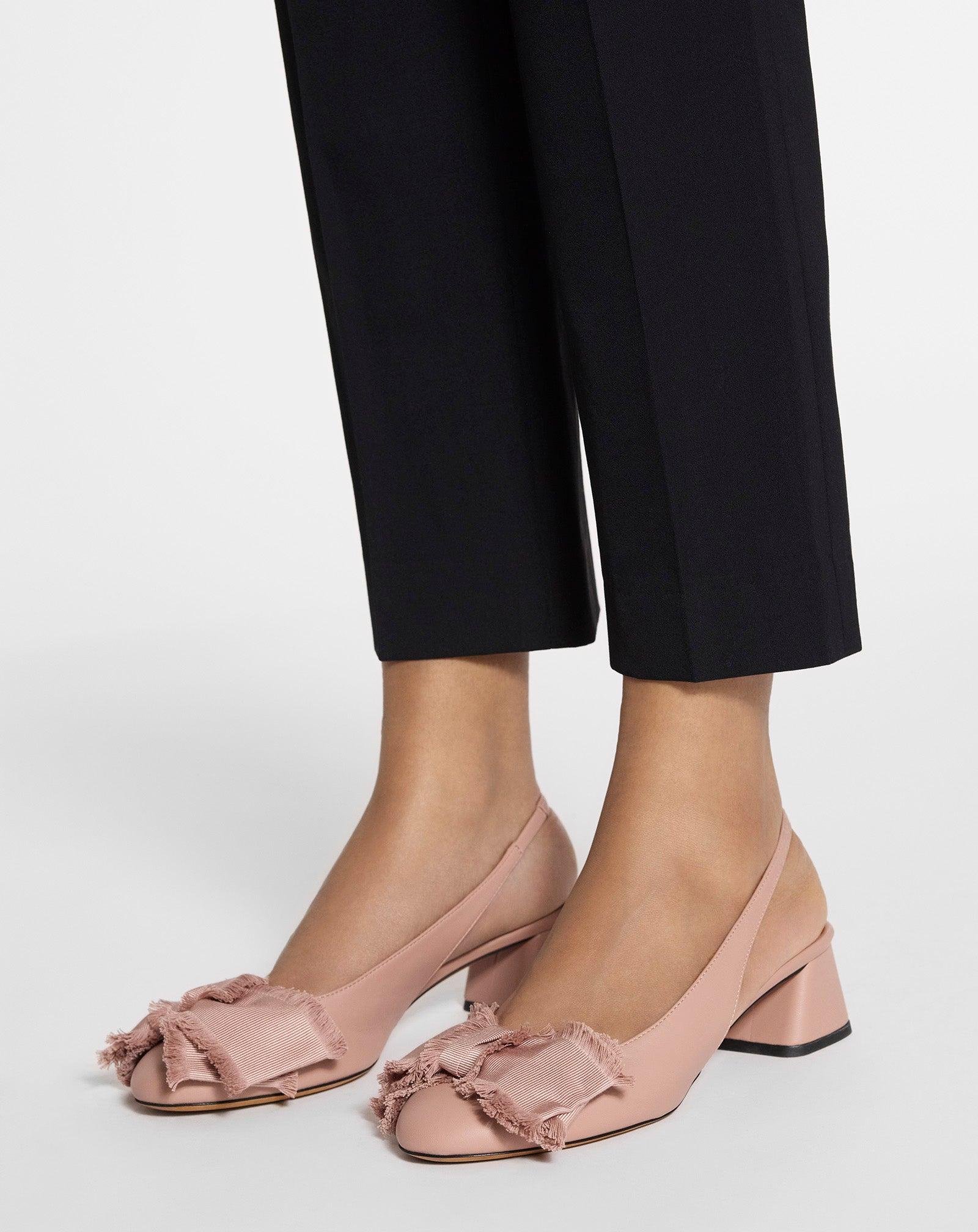 Lanvin bow ballerina flats worn with cropped black trousers