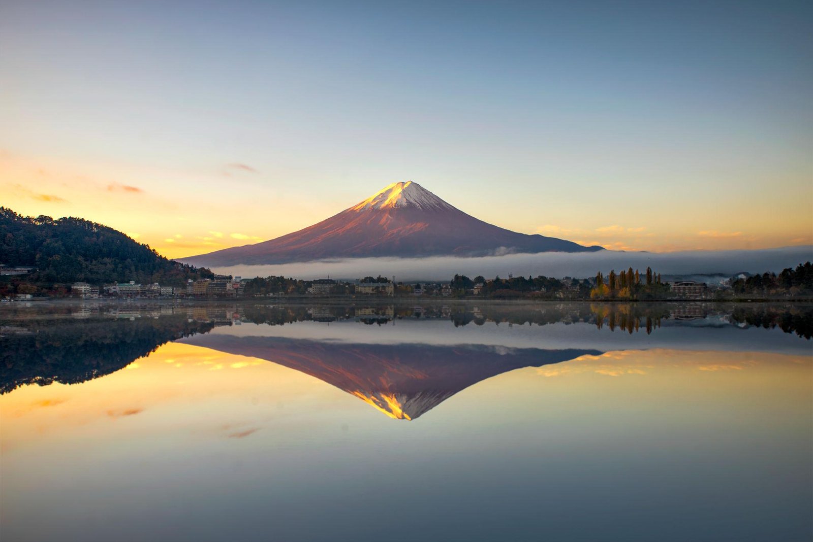 Mount Fuji illuminated by golden morning light above Lake Kawaguchiko