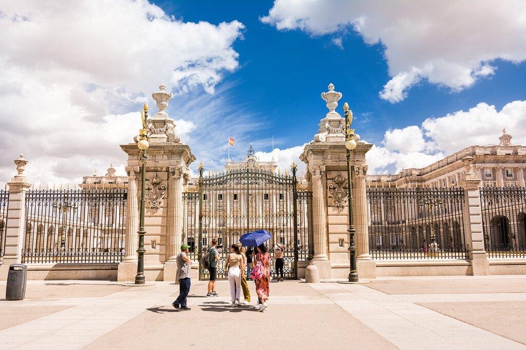 Morning visitors approaching the Royal Palace of Madrid