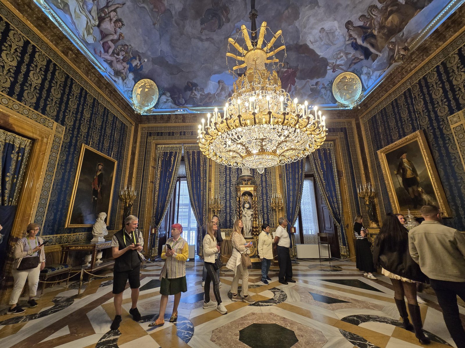 Visitor examining an ornate room inside the Royal Palace of Madrid